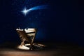 Nativity of Jesus, empty manger at night with bright lights. Royalty Free Stock Photo