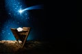 Nativity of Jesus, empty manger at night with bright lights. Royalty Free Stock Photo