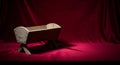 Nativity manger resting on deep crimson luxury Royalty Free Stock Photo