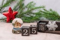 Nativity scene about the Birth of Jesus Christ in a glass ball. Calendar cubes and spruce branches on a gray background. Christmas Royalty Free Stock Photo