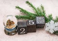 Nativity scene about the Birth of Jesus Christ in a glass ball. Calendar cubes and spruce branches on a gray background. Christmas Royalty Free Stock Photo