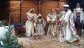 Nativity scene crÃÂ¨che with life size figures in stable with straw Royalty Free Stock Photo