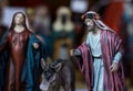 Nativity scene with Joseph figure next to donkey and mother Mary