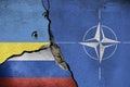 nato flag, ukranian flag with bullet holes, and the russian flag.