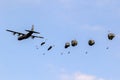 NATO military parachutist paratroopers parachute jumping out of a Ramstein based Lockheed C-130J Hercules transport plane. The