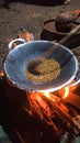 Natuna Regency, November 2021. Cooking rice to be used as emping typical food natuna community