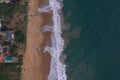 Natural aerial drone bird view day shot of the sea shore with a road, beautiful villas, green trees, yellow sand, turquoise blue