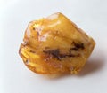 Natural amber stone. Amber nugget on white background. Royalty Free Stock Photo