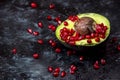 Natural antioxidants - natural antioxidants, avocado fruit sprinkled with pomegranate seeds