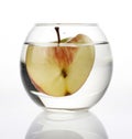 Natural apple inside a glass ball in the shape of an apple