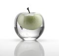 Natural apple inside a glass ball in the shape of an apple