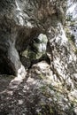 Natural arch bellow Poludnica hill in Nizke Tatry mountains in Slovakia with trees on the background