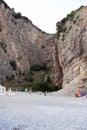 Impressive steep sheer rock that frames up a pebbly beach making an amazing cove. Palinuro, Italy.