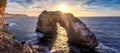 Natural arch in the mediterranean sea, sunrise with golden sunbeam and beautiful colourful sky, Santanyi, Mallorca, Spain Royalty Free Stock Photo