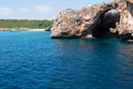 Natural arch and recreational boat at Cala Antena