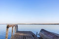 Natural autumn landscape with inverted boat on lakes shore. Fishing concept. Rusty ancient boat at old pier Royalty Free Stock Photo