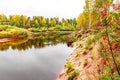 Natural autumn landscape with river shore and green, yellow and red leaves trees forest view on fall background Royalty Free Stock Photo