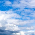 dense white and gray clouds in blue sky on summer