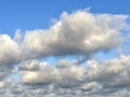 Natural background. Layered and cumulus white clouds in the blue sky