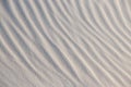 Natural background with patterns on the sand of dune. Background, sand, light, beige, wave, reflect, shadow, summer. Beautiful Royalty Free Stock Photo