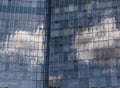 Natural background of reflection of clouds and sky in the windows of buildings Royalty Free Stock Photo