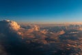 Natural background of sky, sunset above dark clouds, view through window from inside of airplane during the flight Royalty Free Stock Photo