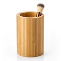 Natural bamboo holder with a single makeup brush inside on a white background container organizer Royalty Free Stock Photo