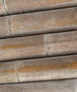 Natural bamboo trunk dry weathered, part of a wooden construction stacked of round trunks background Royalty Free Stock Photo