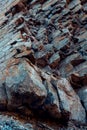 Natural basalt rock with cracks and crevices with a red color coming from iron