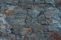 Graphite stone wall background with cracks and crevices