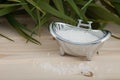 Natural bath salt, organic products placed on wooden background with spa accessories.