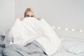 Natural beautiful woman sitting in bed.