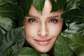 Natural Beauty. Beautiful Woman Face In Green Leaves. Royalty Free Stock Photo