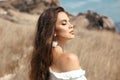 Natural beauty brunette outdoor portrait. Beautiful young bride woman with long wavy hair enjoying in the hay field.  Romantic Royalty Free Stock Photo