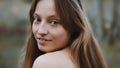 Natural beauty concept. Close up shot of caucasian woman with beautiful green eyes and frekles. Smiling girl.