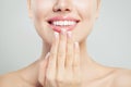 Natural beauty concept. Closeup female smile with natural pink lips and french manicure hand Royalty Free Stock Photo