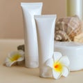 Natural beauty cosmetic tube mockup product for skincare with sea shell tropical plumeria flowers on stone pedestal