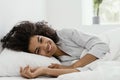 African american woman lying on bed, looking at camera Royalty Free Stock Photo