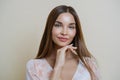 Natural beauty and people concept. Portrait of beautiful dark haired young European woman touches jawline gently, dressed in Royalty Free Stock Photo