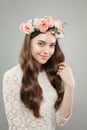 Natural beauty portrait. Beautiful smiling woman with clear skin, long healthy hair and flowers Royalty Free Stock Photo