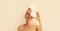 Natural beauty portrait of happy smiling young caucasian woman touches her clean skin applying face cream while drying wet hair Royalty Free Stock Photo