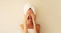 Natural beauty portrait of happy smiling young caucasian woman touches her clean skin, covers her eyes while drying wet hair with Royalty Free Stock Photo