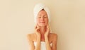 Natural beauty portrait of happy smiling young caucasian woman touches her clean skin while drying wet hair with white wrapped Royalty Free Stock Photo