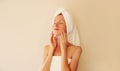 Natural beauty portrait of happy smiling young caucasian woman touches her clean skin while drying wet hair with white wrapped Royalty Free Stock Photo