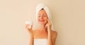 Natural beauty portrait of happy smiling young caucasian woman touches her clean skin while drying wet hair with white wrapped Royalty Free Stock Photo