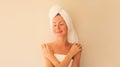 Natural beauty portrait of happy smiling young caucasian woman touches her clean skin while drying wet hair with white wrapped Royalty Free Stock Photo