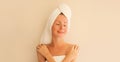 Natural beauty portrait of happy smiling young caucasian woman touches her clean skin while drying wet hair with white wrapped Royalty Free Stock Photo