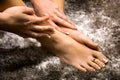 Beautiful woman feet and hands touching the soft skin, pampering foot and hand care, luxury french manicure and pedicure on nails