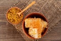 Natural bee liquid honey and honeycomb in bowl on wooden table background, flat lay Royalty Free Stock Photo