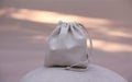 Natural Beige Drawstring Sack on Soft Pink and Gray Surface Royalty Free Stock Photo